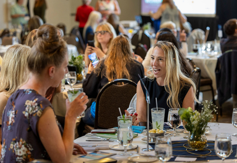 Tow people meeting at a crowded event.